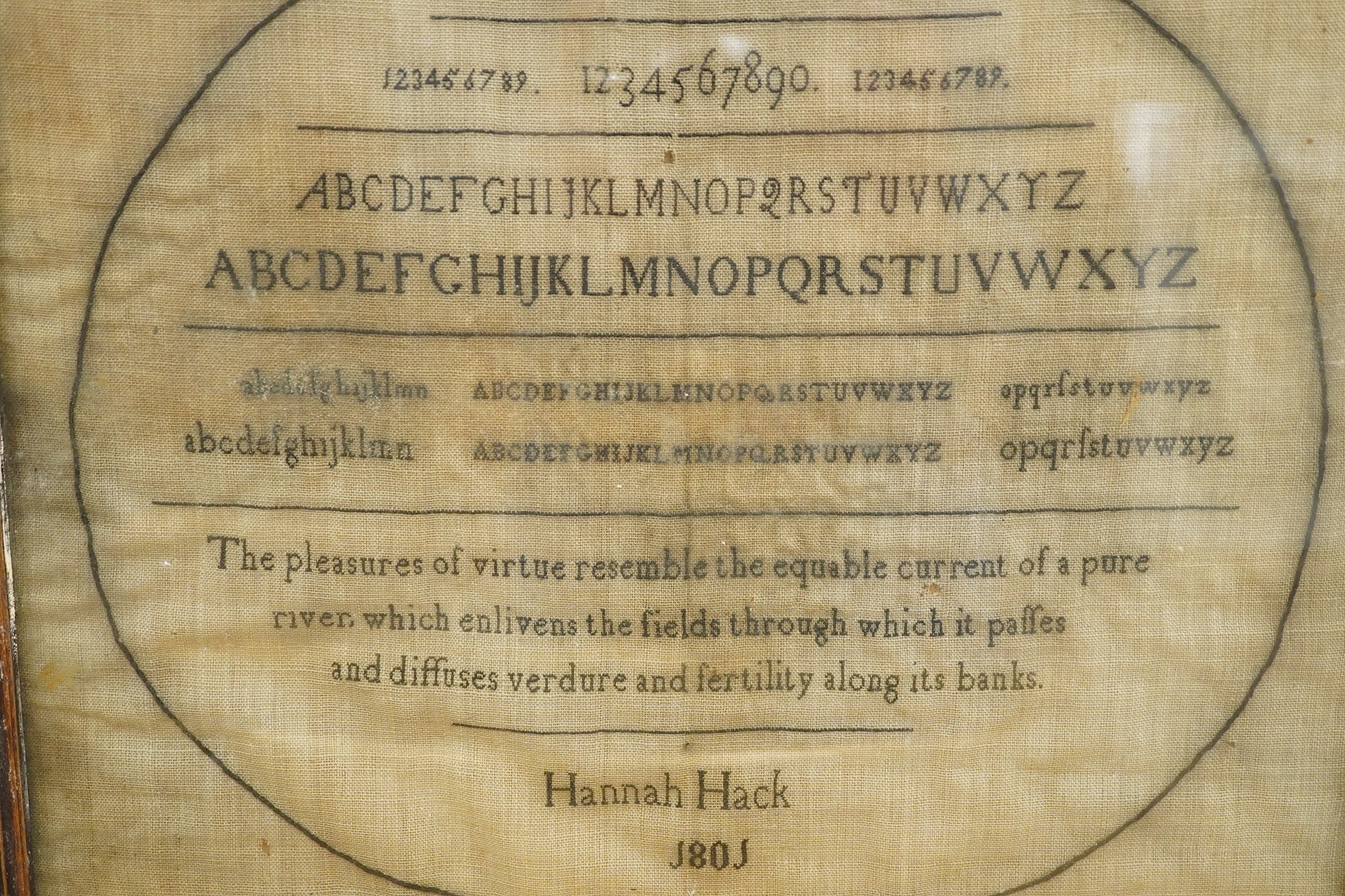 A Hannah Hack, York School, 1801 sampler, sewn within an embroidered black oval border, headed with York School above a row of numerals and two rows of lower case and capital letters, with a pastoral verse below then sig